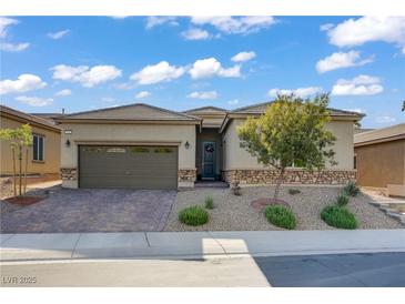 Charming single-story home featuring desert landscaping, a brick driveway, and a two-car garage at 961 Cutter St, Henderson, NV 89011
