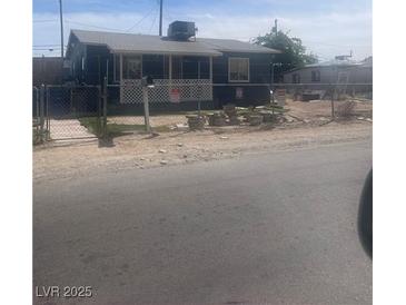Charming single-story home featuring an enclosed front porch and a well-maintained yard at , Las Vegas, NV 89104