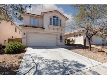 Two-story home featuring a red tile roof, white stucco, concrete driveway and low maintenance desert landscaping at 10075 Yellow Canary Ave, Las Vegas, NV 89117