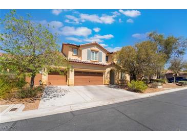 Charming two-story home with a three-car garage, desert landscaping and neutral paint at 10259 Wolves Den Ln, Las Vegas, NV 89178