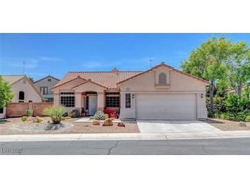 Charming single-story home with a well-manicured front yard and a two-car garage at 1931 Jasper Creek Pl, Las Vegas, NV 89123