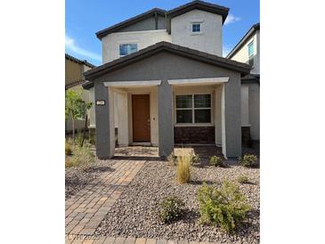 Charming home with a cozy front porch and desert landscaping offers curb appeal at 219 Vanhoy Ave, Henderson, NV 89011