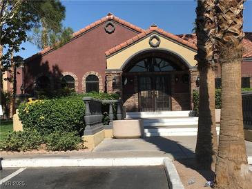 Attractive clubhouse entry featuring landscaped bushes, a tile roof and welcoming double-door entrance at 4050 Pacific Harbors Dr # 217, Las Vegas, NV 89121