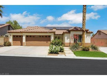 Charming single-story home featuring a three-car garage, desert landscaping, and a tile roof, perfect for curb appeal at 4128 Tarkin Ave, Las Vegas, NV 89120