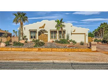 Charming single-story home featuring stucco exterior, desert landscaping, and an attached two-car garage at 440 N Lisbon St, Henderson, NV 89015