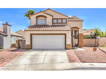 Charming two-story home featuring a tile roof, neutral stucco, and an attached two-car garage at 4514 Calico Cliff Ct, North Las Vegas, NV 89031