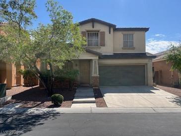 Charming two-story home featuring a well-manicured front yard and a two-car garage at 6554 Macdoogle St, Las Vegas, NV 89166