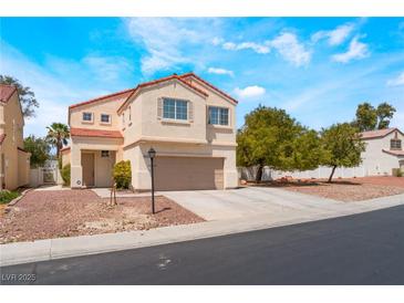 Charming two-story home with red tile roof and neutral stucco exterior, showcasing a well-maintained front yard at 6715 Maple Mesa St, North Las Vegas, NV 89084