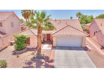 Charming single-story home with desert landscaping, tile roof, and a two-car garage at 7909 Sierra Rim Dr, Las Vegas, NV 89131