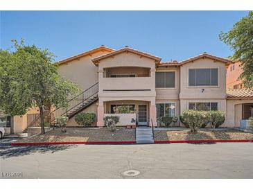 Inviting exterior view of a two-story condo building with well-maintained landscaping and easy access stairs at 8450 Alta Dr # 225, Las Vegas, NV 89145