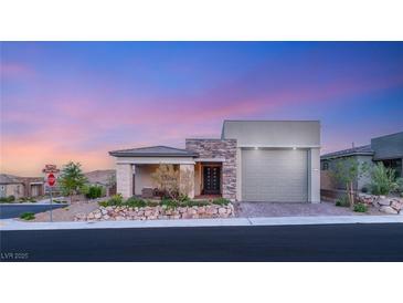 Inviting single-story home featuring a stone facade and a well-manicured front yard at 964 Edinburgh Fields Ct, Las Vegas, NV 89138