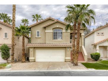Charming two-story home featuring a two-car garage, terra cotta roof, and elegant stairwell entrance at 9966 Mystic Moss St, Las Vegas, NV 89183