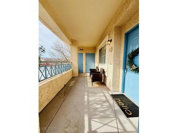 Inviting covered balcony featuring comfortable seating, offering a relaxing outdoor space with beautiful landscape view at 10553 Pine Glen Ave # 202, Las Vegas, NV 89144