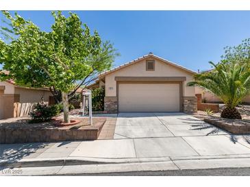 Charming single-story home with a two-car garage, desert landscaping, and mature trees at 11073 Gateview Ln, Las Vegas, NV 89144