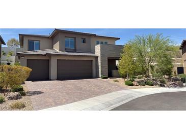 Beautiful two-story home featuring a brick driveway and attached two-car garage at 12428 Lincoln Creek Ave, Las Vegas, NV 89138