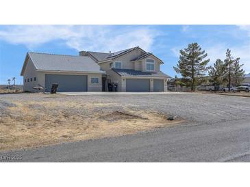 Expansive home featuring a three car garage and ample parking on a large gravel lot at 1581 Cavalry St, Pahrump, NV 89048