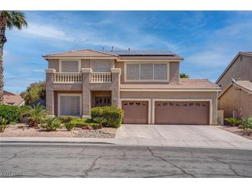 Two-story home boasts a charming balcony, desert landscaping, and a convenient two-car garage at 1790 Castro Hill Ave, Henderson, NV 89012
