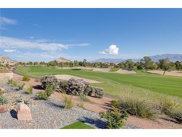 Expansive golf course view featuring lush greenery, sand traps, and mountain backdrop on a sunny day at 2024 Bay Tree Dr, Las Vegas, NV 89134
