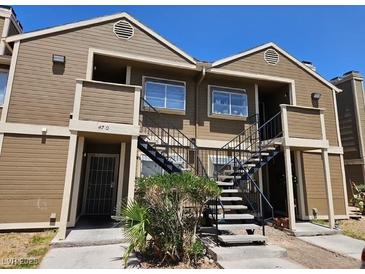 Inviting two-story condo featuring stairs to upper units, and neutral toned horizontal siding at 4720 Krissylouise Way, Las Vegas, NV 89121