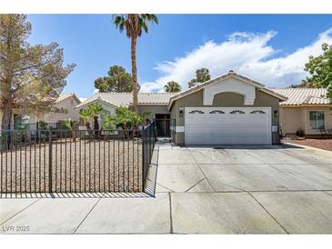 Charming single-story home with desert landscaping and a secure gated yard at 5045 Sock Hop Way, North Las Vegas, NV 89031