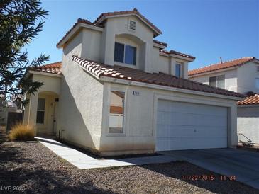 Two-story stucco home with a red tile roof, attached two-car garage, and well maintained landscaping at 7309 Sunspot Dr, Las Vegas, NV 89128