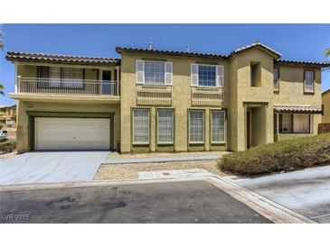 Two-story home with a balcony, white trim and a two car garage at 8143 Retriever Ave, Las Vegas, NV 89147