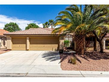 Charming single-story home with a three-car garage, beautiful desert landscaping, and a tiled roof at 9048 Faversham Ct, Las Vegas, NV 89123