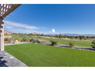 Beautiful backyard featuring lush green artificial turf and a stunning view of the golf course at , Las Vegas, NV 89134