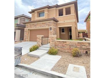 Charming two-story home featuring a stone facade, neutral stucco, and a well-maintained front yard at 10349 Mystic Pine Rd, Las Vegas, NV 89135