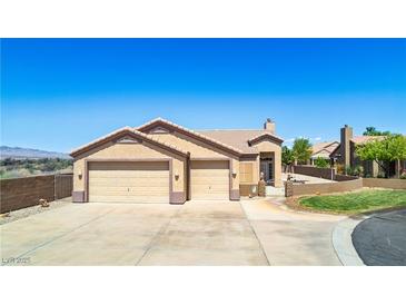 Charming single-story home features a desert-landscaped yard and a spacious three-car garage at 1204 Golf Club, Laughlin, NV 89029