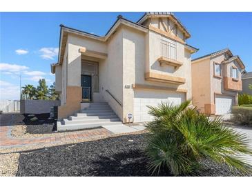 Attractive two-story home featuring a well-manicured front yard and an attached two-car garage at 1808 Quartz Landing Ave, Las Vegas, NV 89183