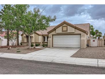 Charming single-story home with a two-car garage, desert landscaping, and a tile roof at 3104 Archwood Way, Las Vegas, NV 89134