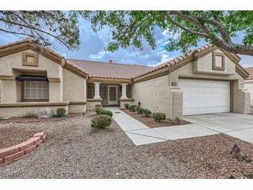 Charming single-story home with a tile roof, two car garage, and desert landscaping at 3104 Archwood Way, Las Vegas, NV 89134