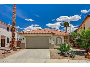 Charming single-story home featuring a two-car garage, desert landscaping, and a classic Spanish tile roof at 1012 Vanier Ct, Henderson, NV 89052