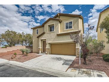 Charming two-story home featuring neutral stucco, a two-car garage, and a well-kept, low maintenance desert landscape at 10513 Bandera Mountain Ln, Las Vegas, NV 89166