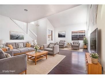 Bright living room with vaulted ceilings, hardwood floors, and neutral decor at 110 Wynntry Dr, Henderson, NV 89074