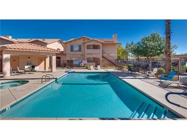 Inviting community pool with sun loungers and seating areas at this complex, perfect for relaxation and socializing at 350 S Durango Dr # 220, Las Vegas, NV 89145