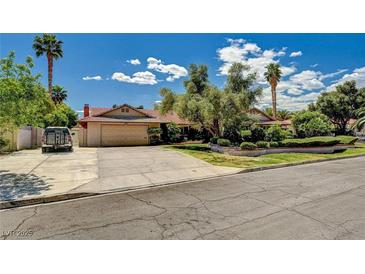 Charming single-story home featuring a spacious driveway, mature trees, and a well-manicured front yard at 3753 S Rosecrest Cir, Las Vegas, NV 89121