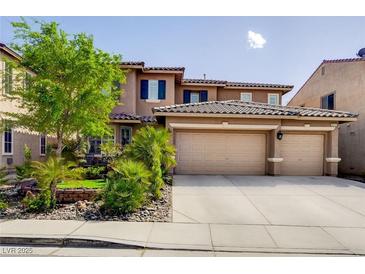 Two-story home with a three car garage, desert landscaping, and a beautiful tiled roof at 4017 Kristina Lynn Ave, North Las Vegas, NV 89081