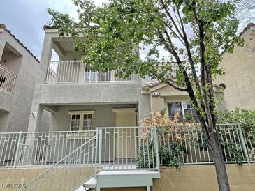 Charming two-story home featuring a cozy balcony and well-maintained landscaping at 7412 Bewitching Ct, Las Vegas, NV 89149
