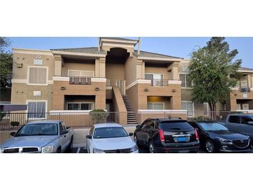 Two-story condo building with well-maintained landscaping and ample parking spaces at 8070 W Russell Rd # 1105, Las Vegas, NV 89113