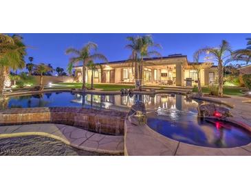 Beautiful backyard pool and spa with lush landscaping, tropical palm trees, and relaxing patio area at 2780 El Camino Rd, Las Vegas, NV 89146