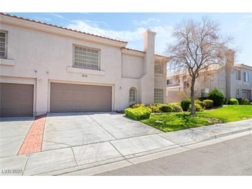 Charming two-story home with well-manicured lawn and mature landscaping at 502 Cosmic Star Pl, Henderson, NV 89052