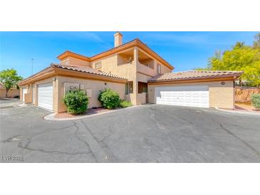 Beautiful two-story home featuring a tile roof, multiple garages, and manicured landscaping at 6916 Dorita Ave # 102, Las Vegas, NV 89108