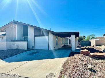 Spacious one-story home featuring a large garage and charming desert landscaping at 6955 Grassy Knoll St, Las Vegas, NV 89147