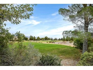 Scenic golf course view with lush green grass and mature trees creating a serene backdrop at 7908 House Sparrow St, North Las Vegas, NV 89084