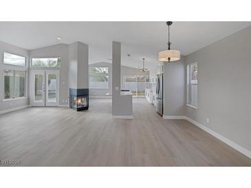 Spacious living room featuring a fireplace and plenty of natural light at 8228 Lauderdale Ct, Las Vegas, NV 89128