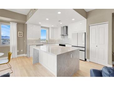 Bright kitchen features sleek white cabinetry, stainless steel appliances, and a large center island at 8255 Las Vegas Blvd # 1422, Las Vegas, NV 89123