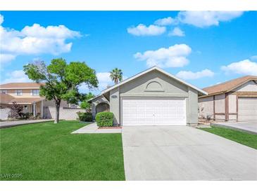 Charming single-story home with lush lawn and two car garage at 908 Coral Isle Way, Las Vegas, NV 89108