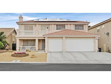 Charming two-story home showcasing a cozy balcony, front-facing two-car garage, and tasteful landscaping at 9815 Ramhorn Canyon St, Las Vegas, NV 89183